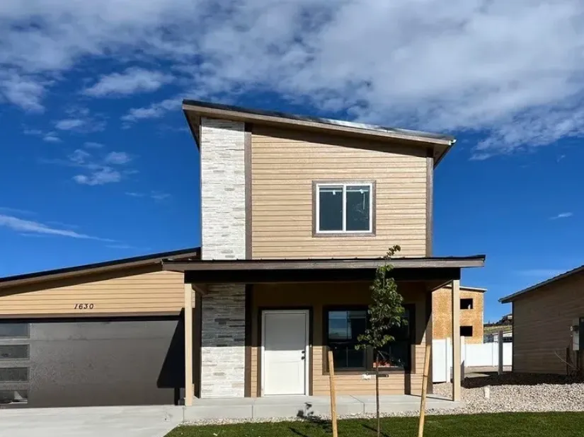 Contemporary two-story Monument home with tan siding and a single-car garage